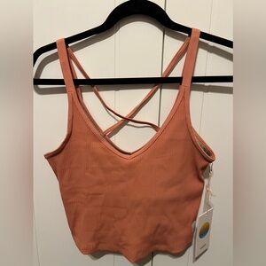 Women’s salmon-colored Vuori support tank top.